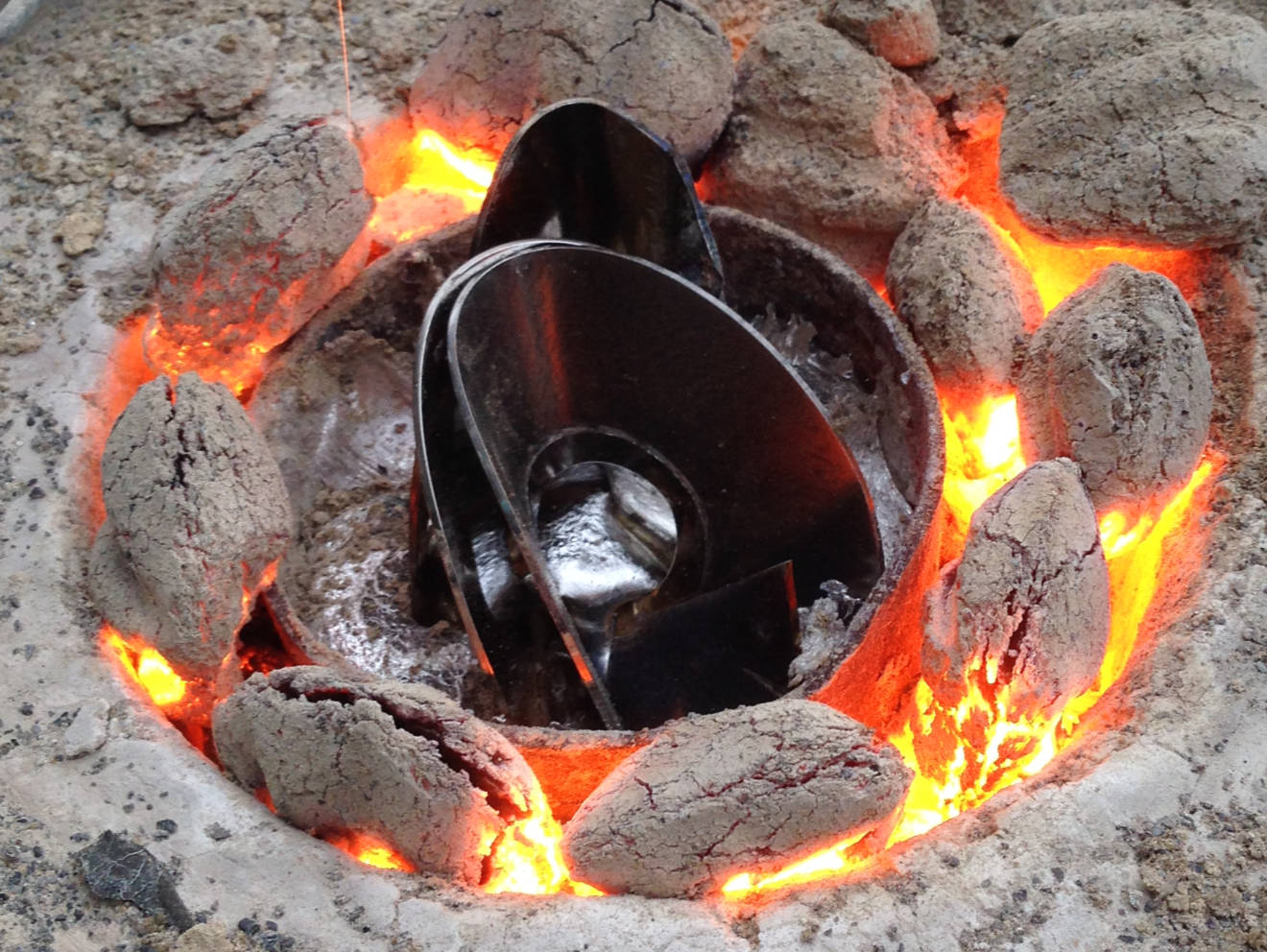 Hard drive platters sitting next to an aluminum forge